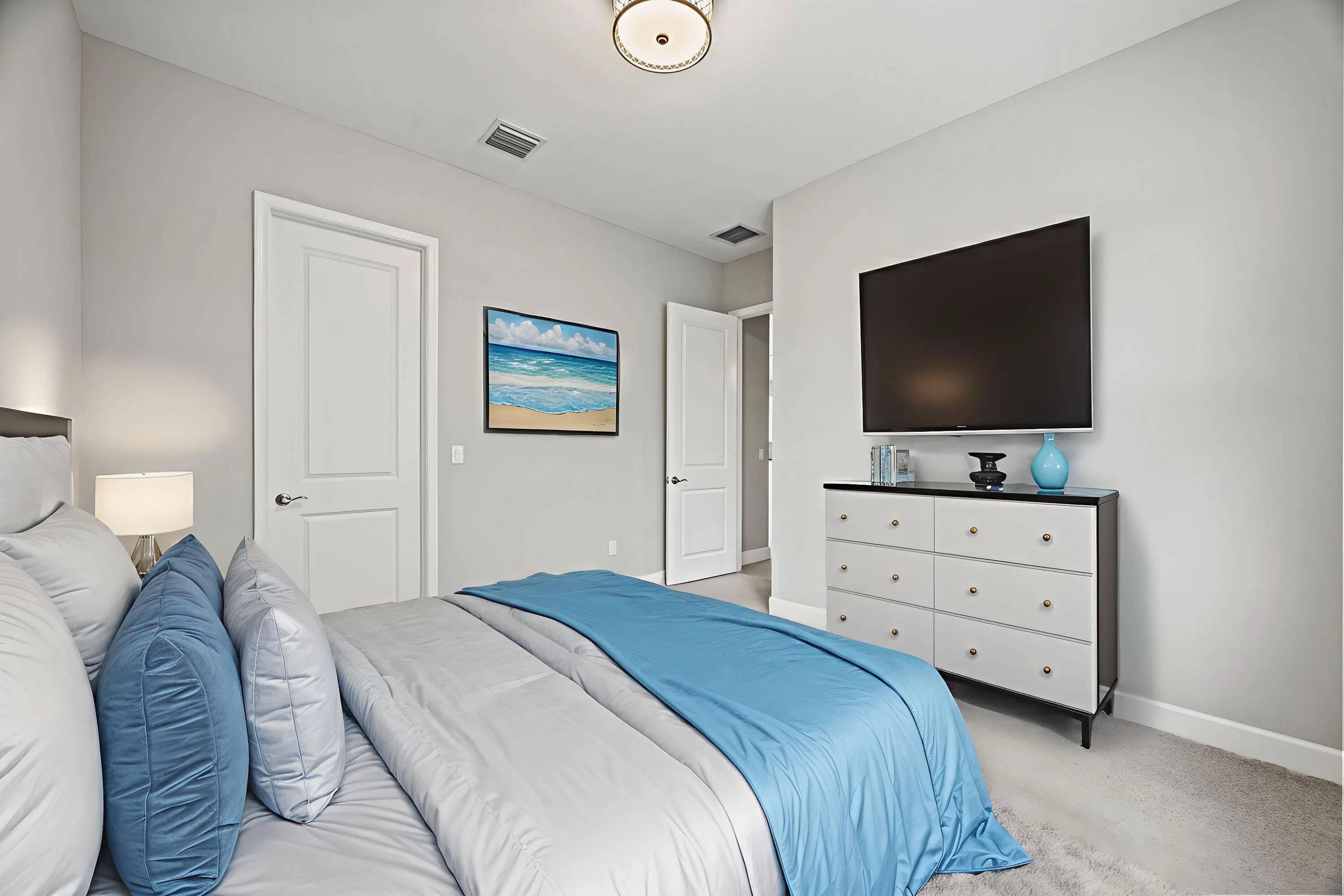 Recessed lighting, light-toned carpeting, and a ceiling-mounted light fixture