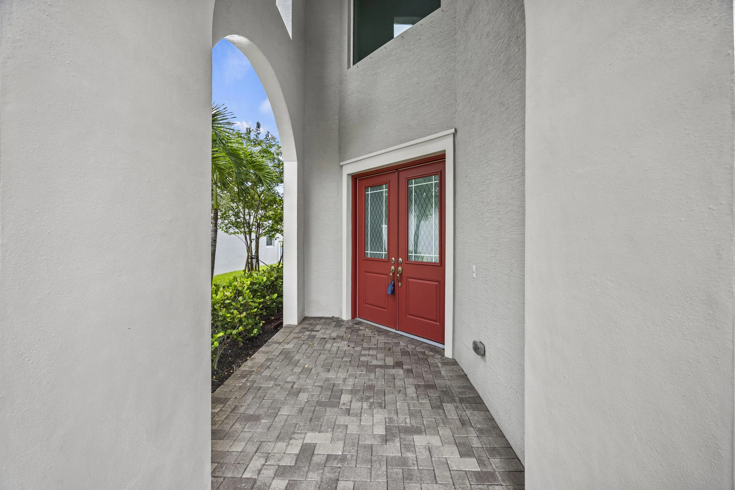 Textured exterior walls with an arched entryway