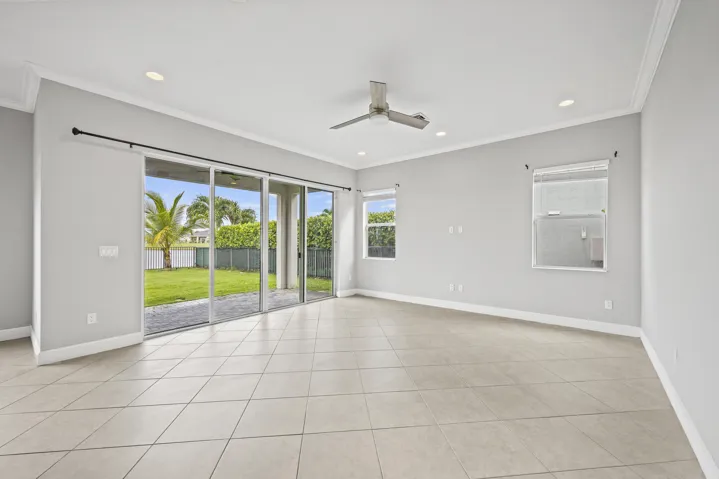Spacious room with tile flooring, crown molding, recessed lighting, and a ceiling fan
