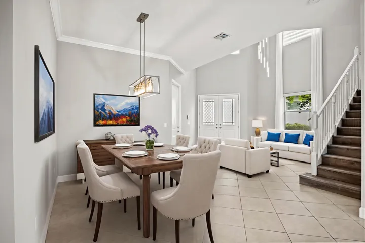 Vaulted ceilings, tiled flooring, wood-finish staircase, double entry doors with decorative glass, and crown molding