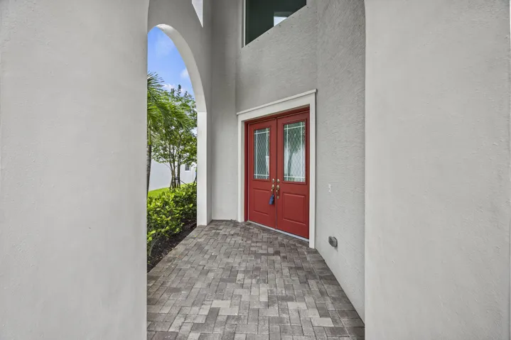 Textured exterior walls with an arched entryway