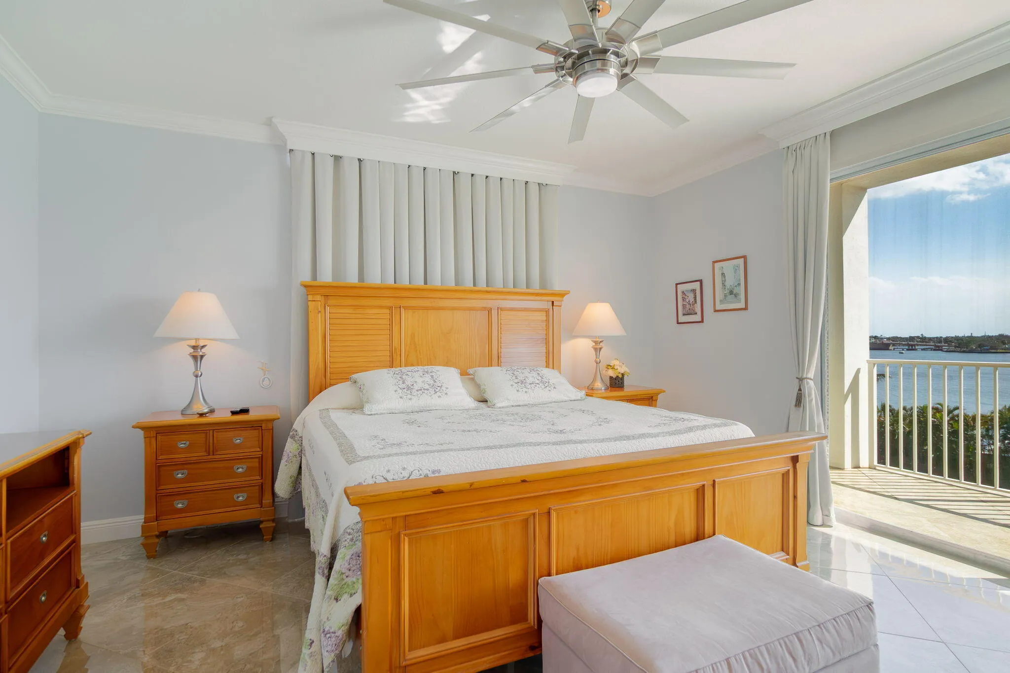 Curtains behind bed cover floor to ceiling windows looking directly at the intracoastal.