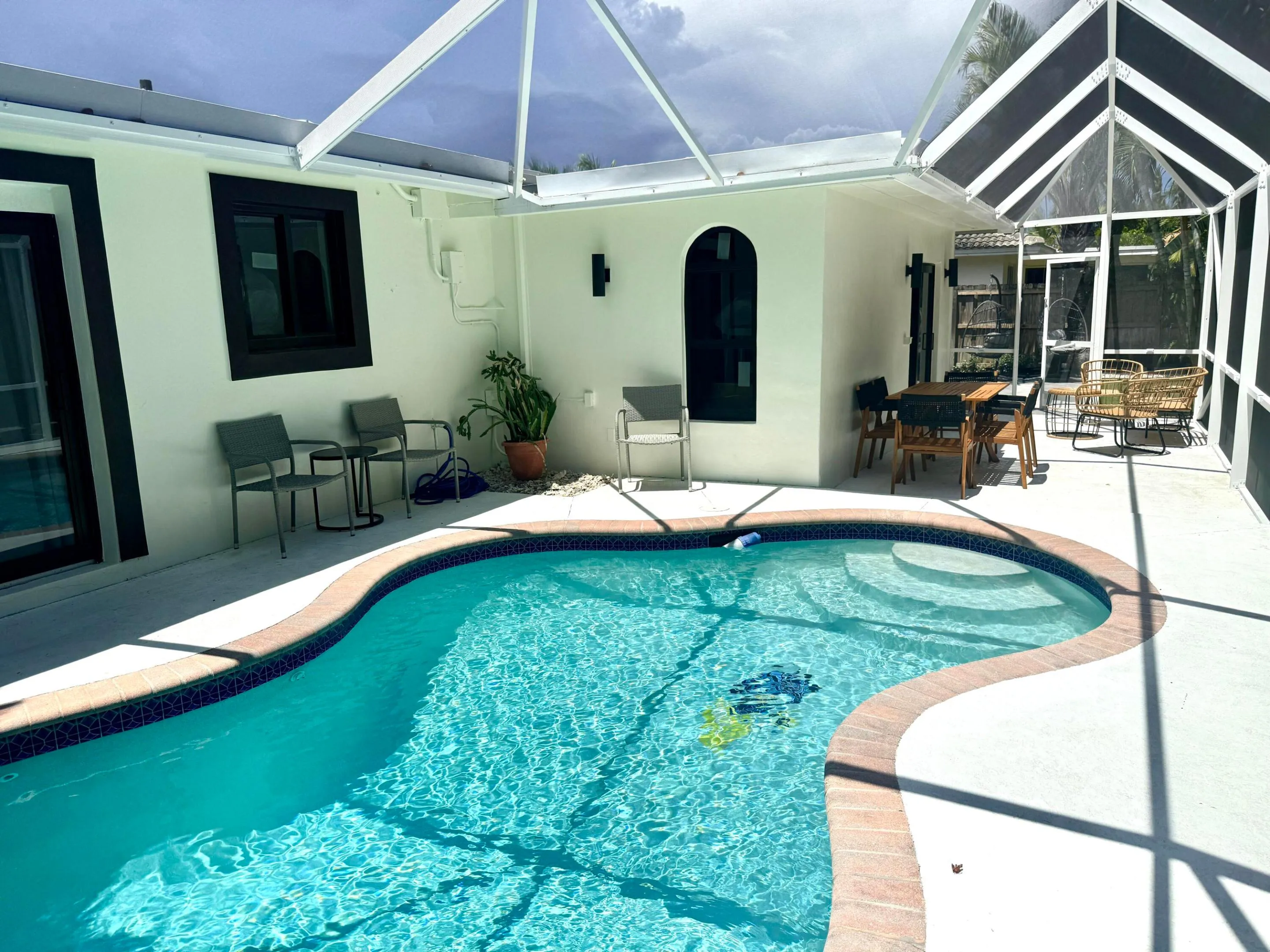 Back of home with pool and sitting area