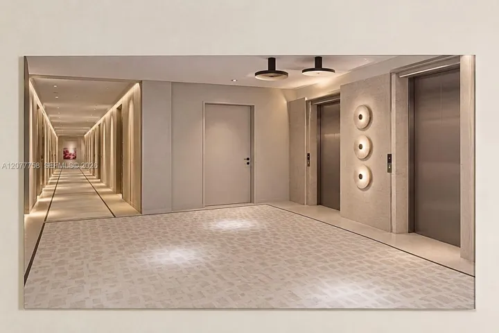 Hallway with integrated ceiling lighting, recessed wall lighting, and two stainless steel elevators