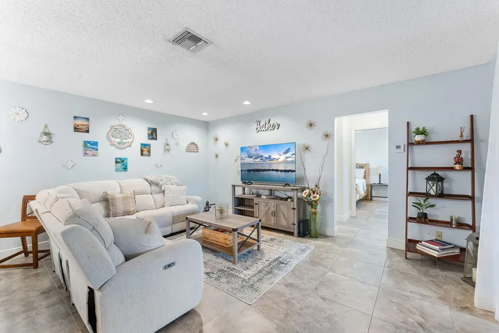 Recessed lighting illuminates ceramic tile flooring