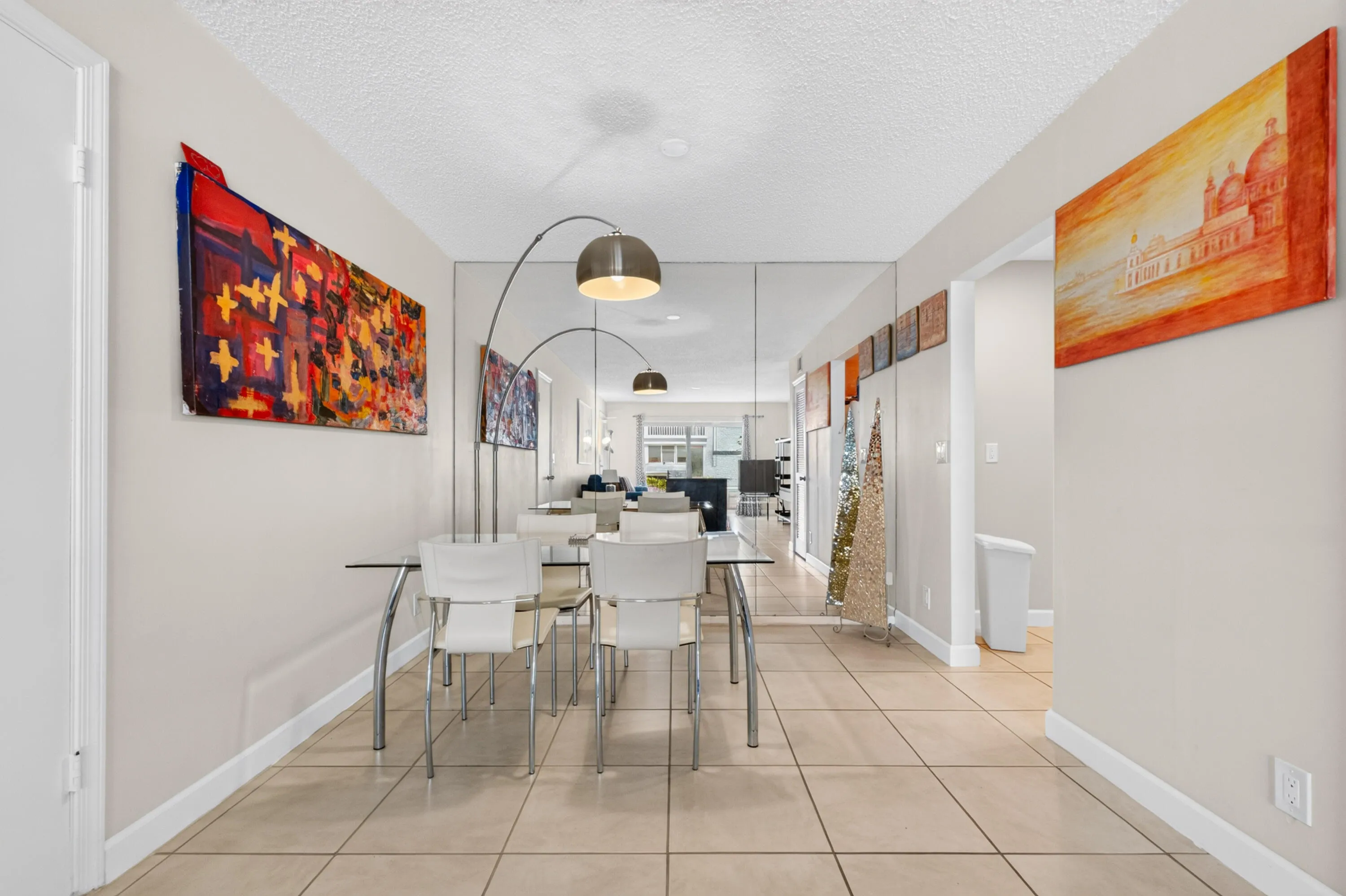 Recessed lighting illuminates the space, featuring light-toned tile flooring and painted walls