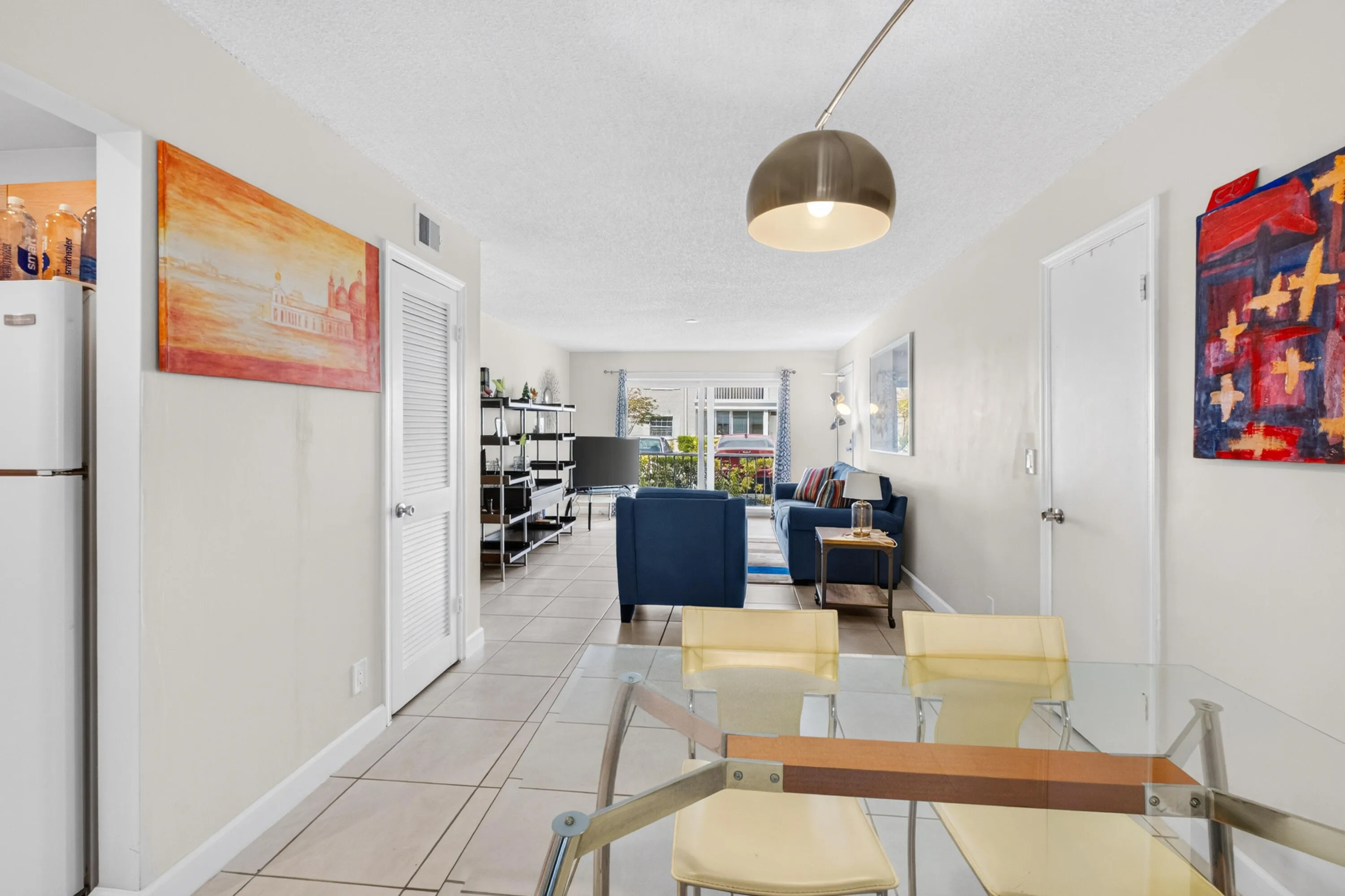 Tile flooring throughout, recessed lighting, and a modern pendant light fixture