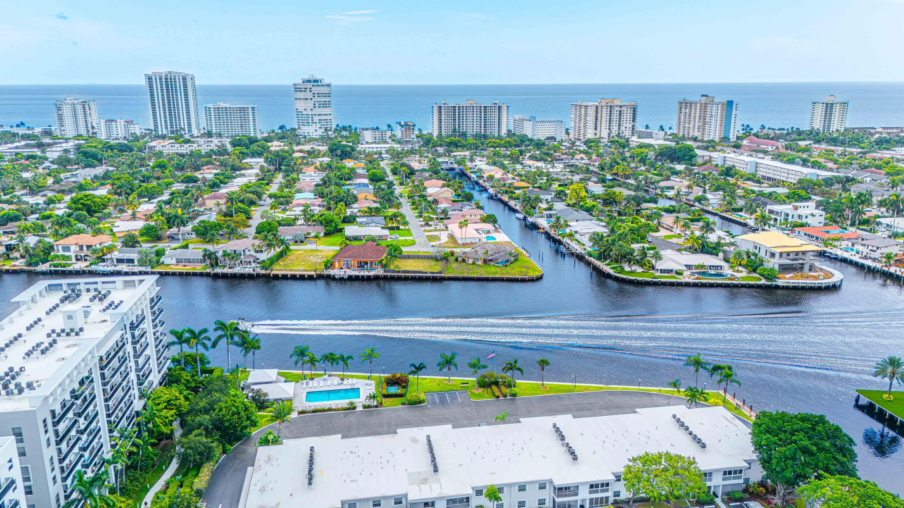 Waterfront living with direct intracoastal access, resort-style heated pool with surrounding hardscape and mature landscaping, expansive water views, and proximity to high-rise amenities and downtown skyline in an established residential community