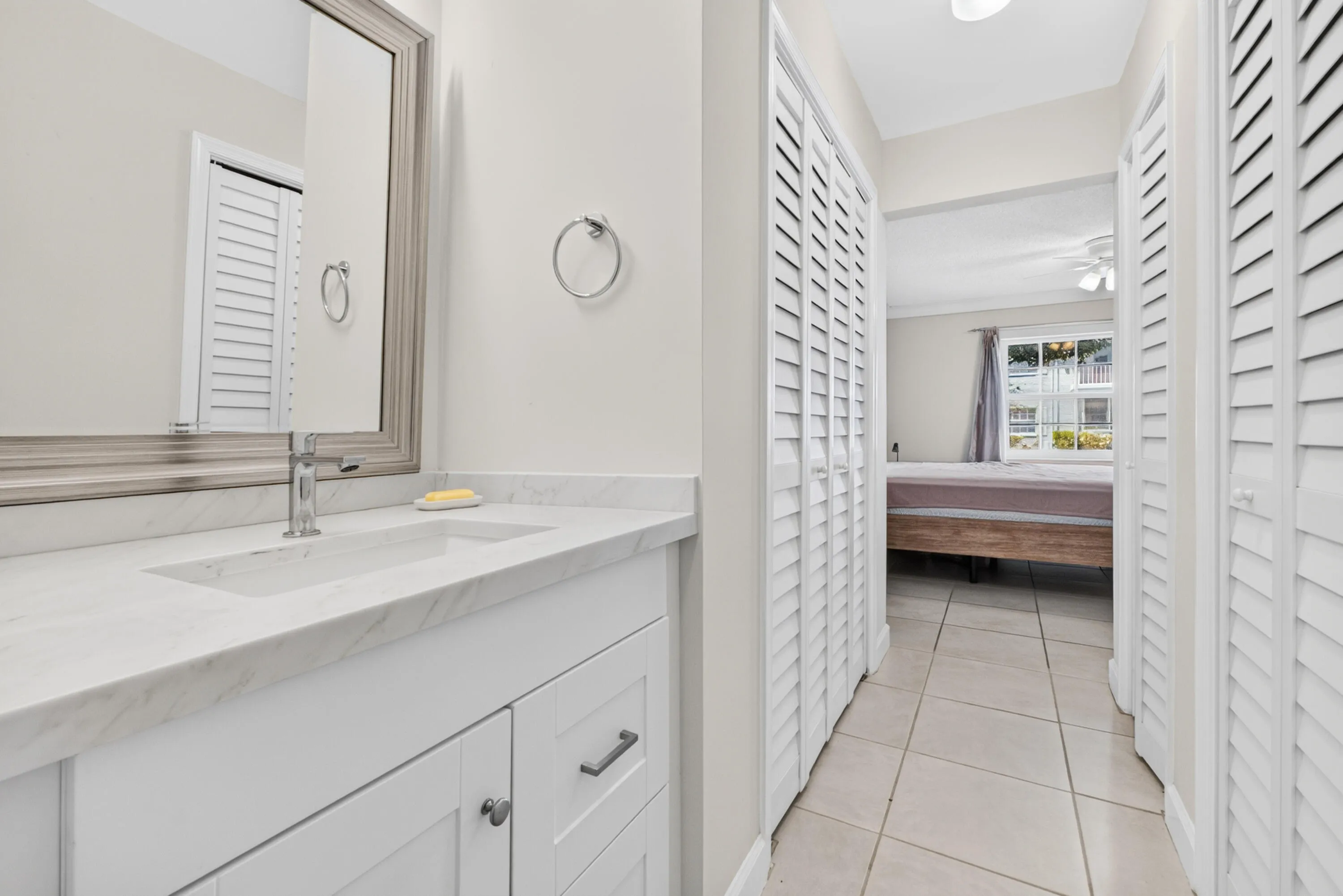 White vanity with an integrated rectangular sink and polished chrome faucet