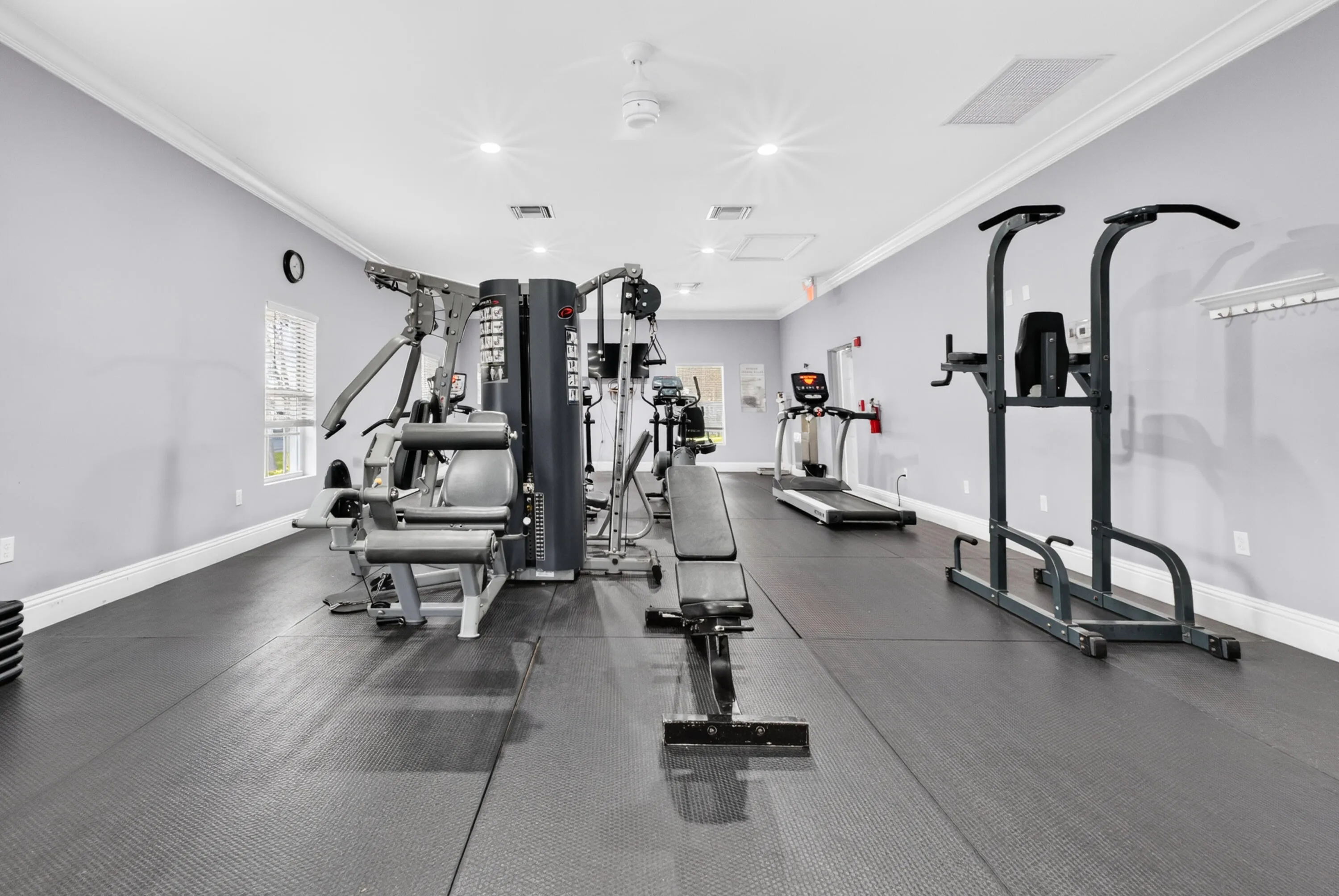 Fitness area featuring rubber flooring, recessed lighting, and crown molding