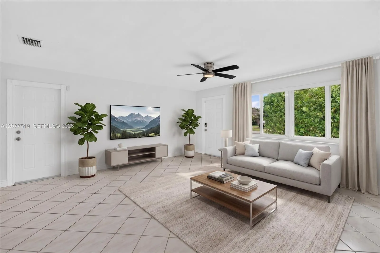 Bright living room featuring tile flooring, neutral finishes and ample natural light. Virtually-Staged