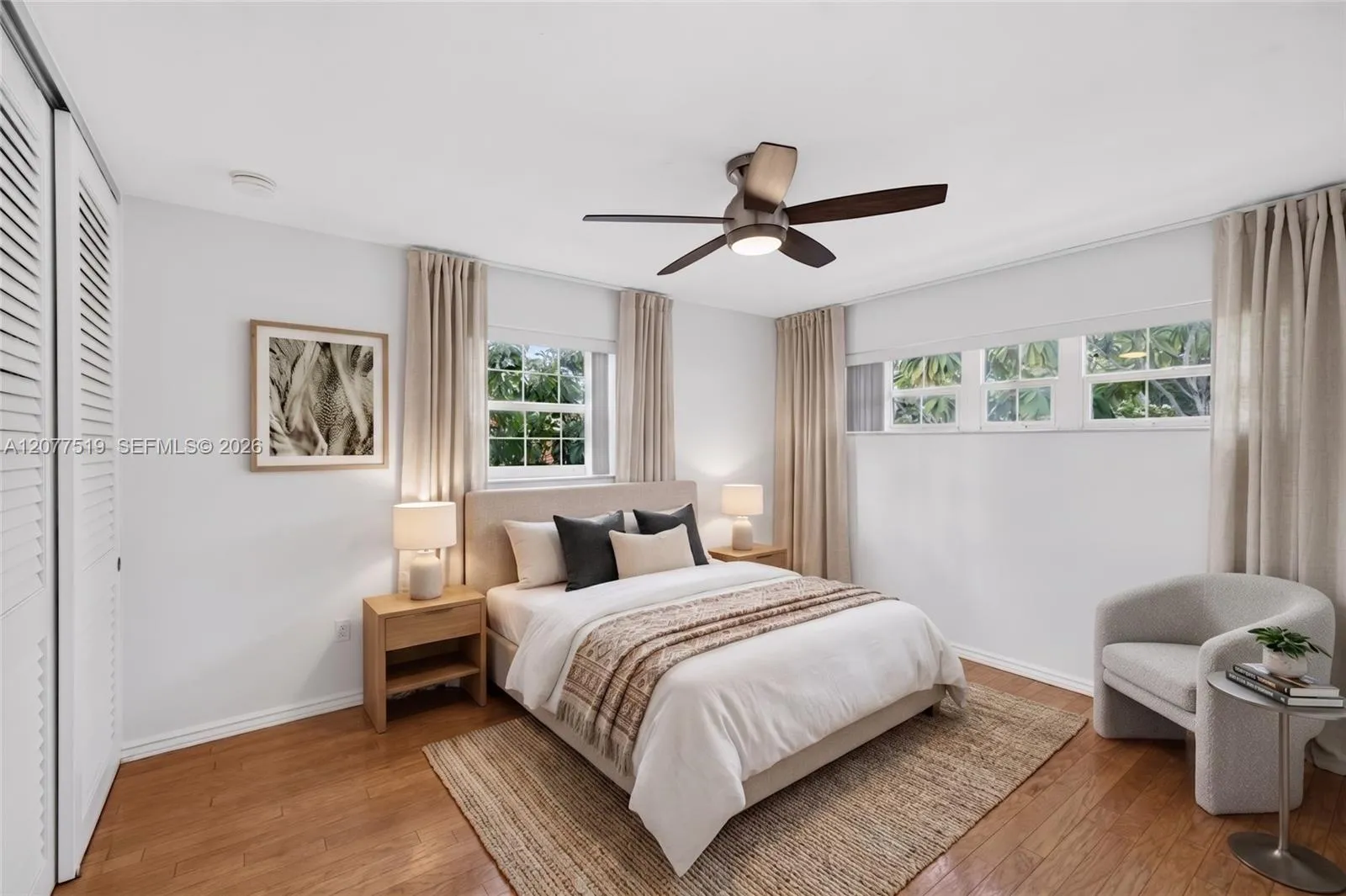 Spacious primary bedroom with updated flooring, blinds and generous closet storage. wood flooring, updated blinds and a walk-in closet. Virtually-Staged.