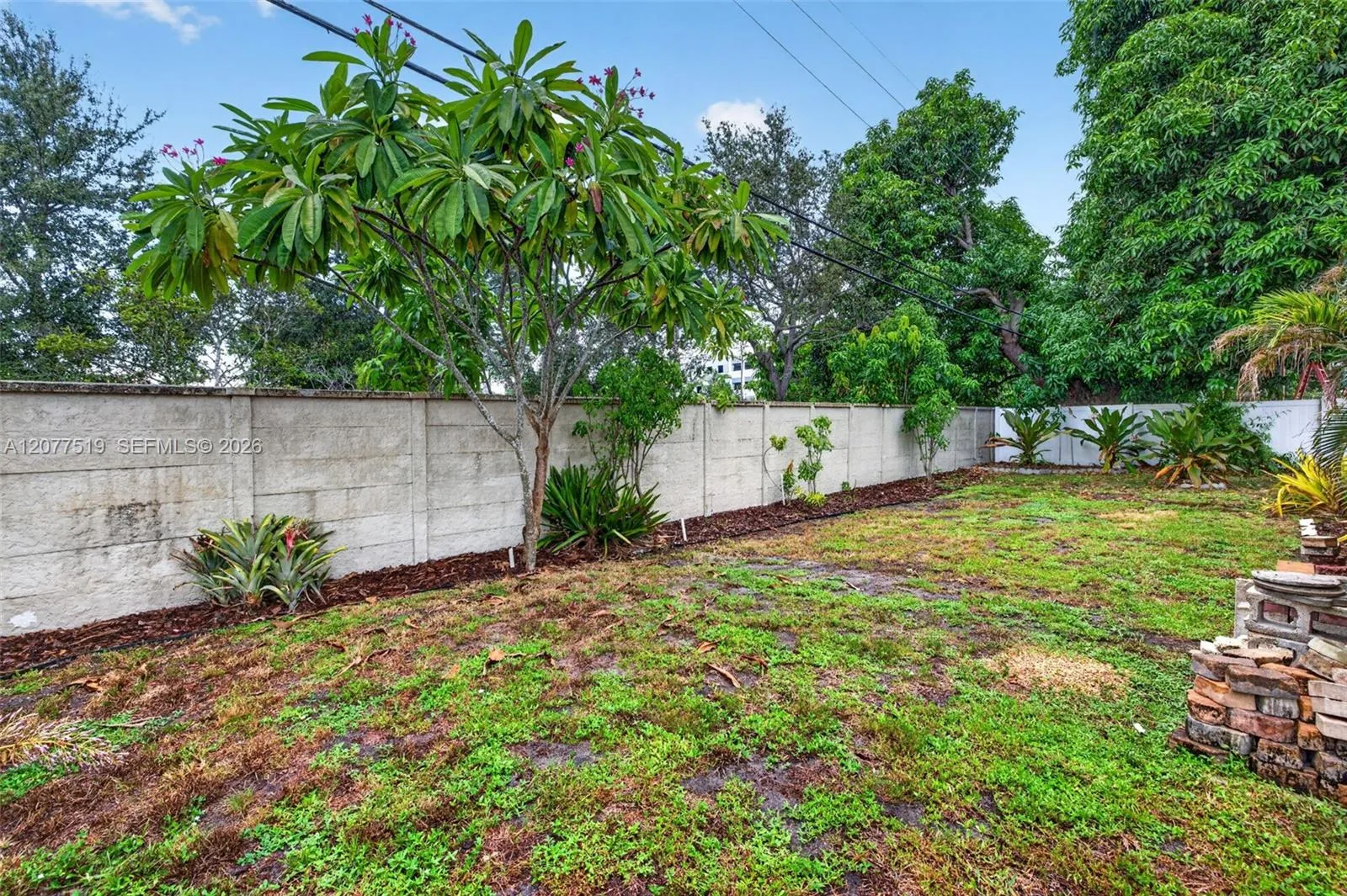 Double-wide gates provide convenient access to the spacious rear yard.
