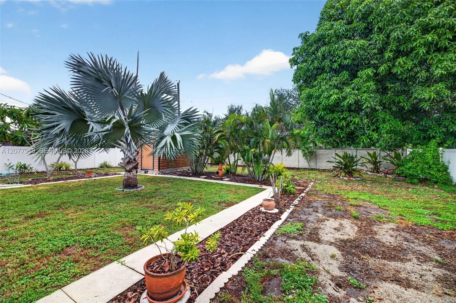 Spacious side yard provides additional outdoor space and convenient property access.