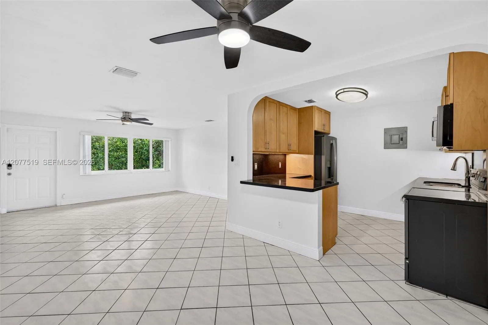Comfortable living area with updated flooring, blinds and an open, inviting feel.