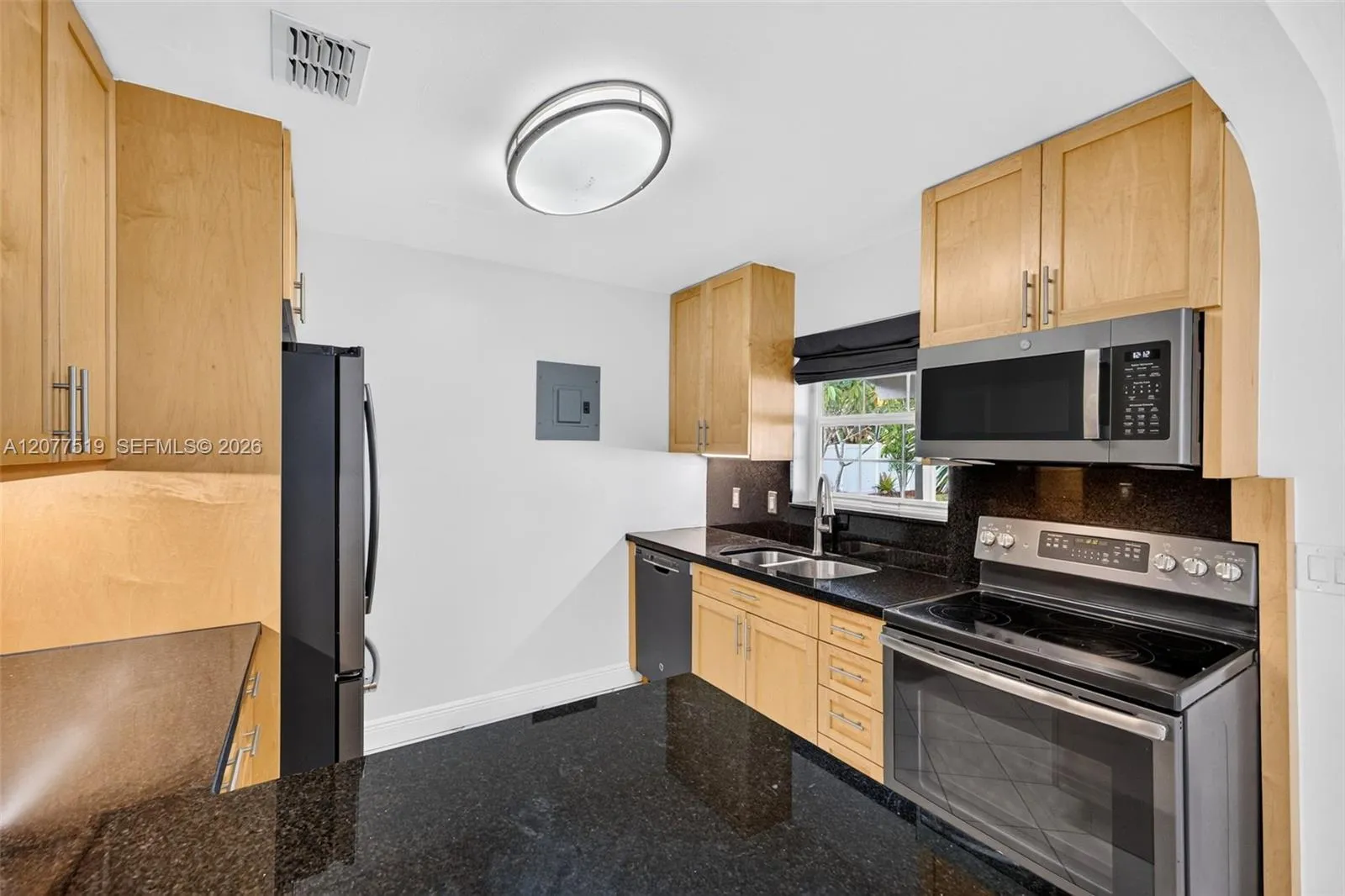Updated 2017 kitchen featuring birch cabinetry, quartz countertops and GE appliances.