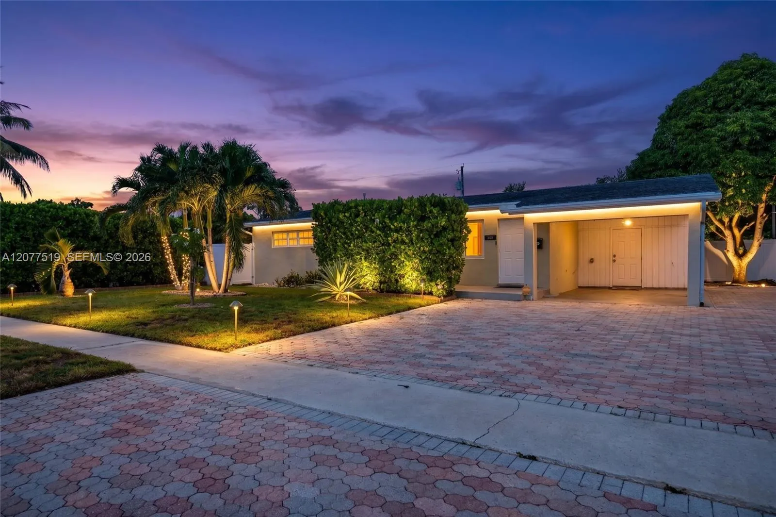 Charming single-story home with a welcoming front entry, covered carport and mature landscaping. Virtually-Enhanced