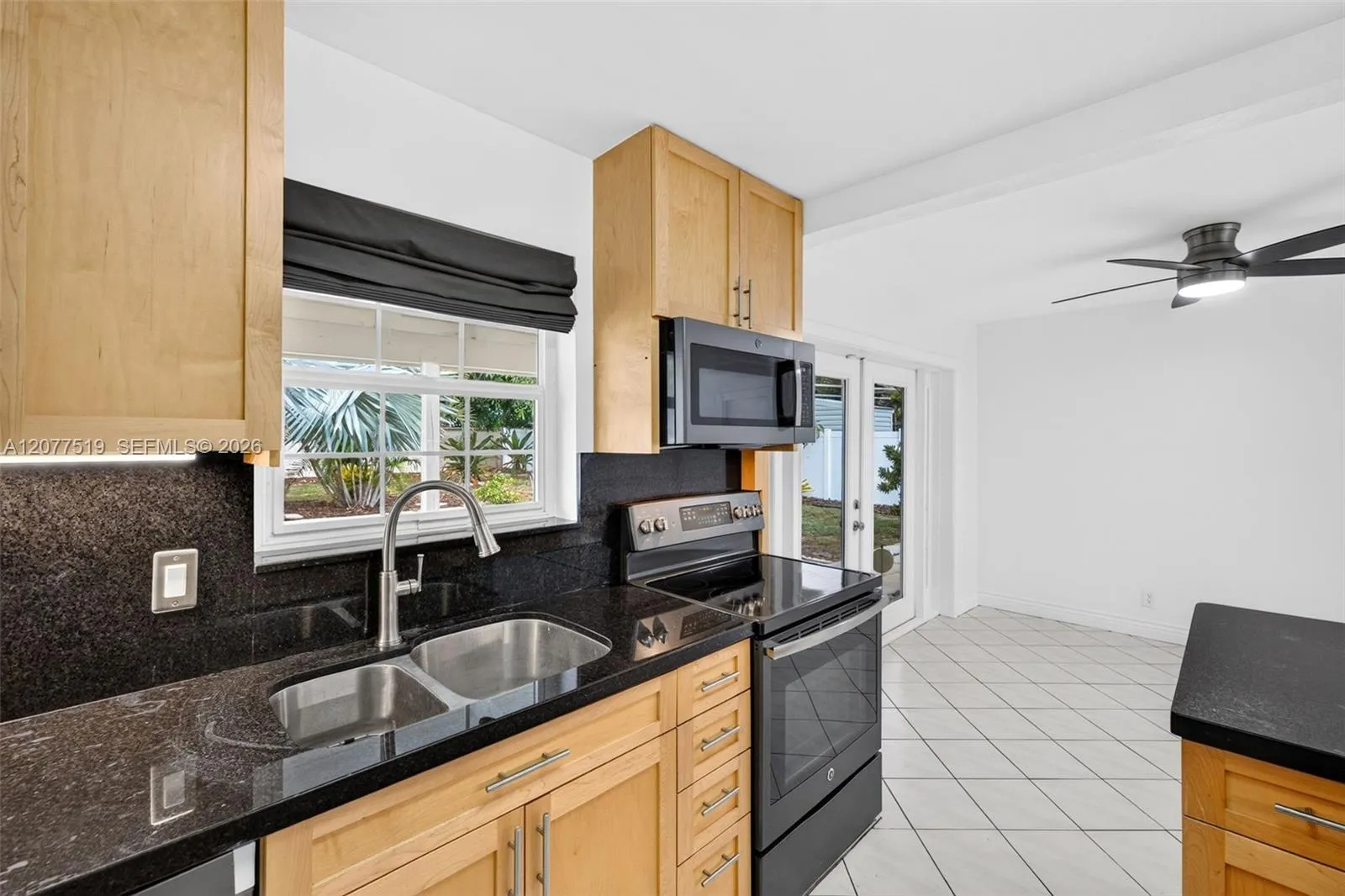Functional kitchen offering an electric range, refrigerator, dishwasher and modern finishes.