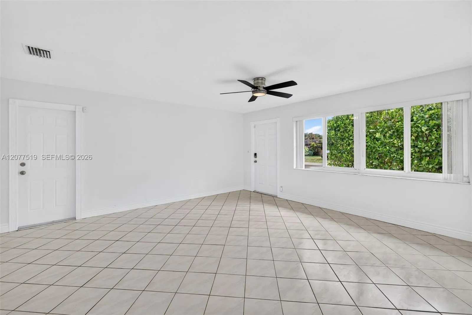 Comfortable living area with updated flooring, blinds and an open, inviting feel.