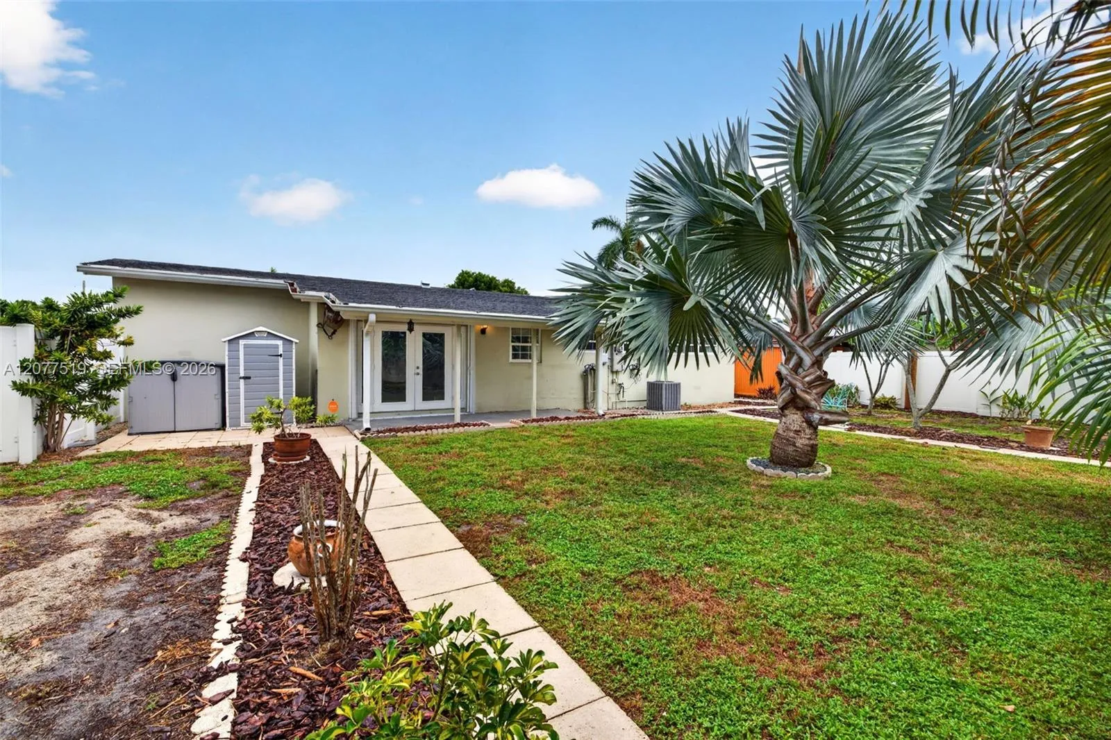 Spacious side yard provides additional outdoor space and convenient property access.
