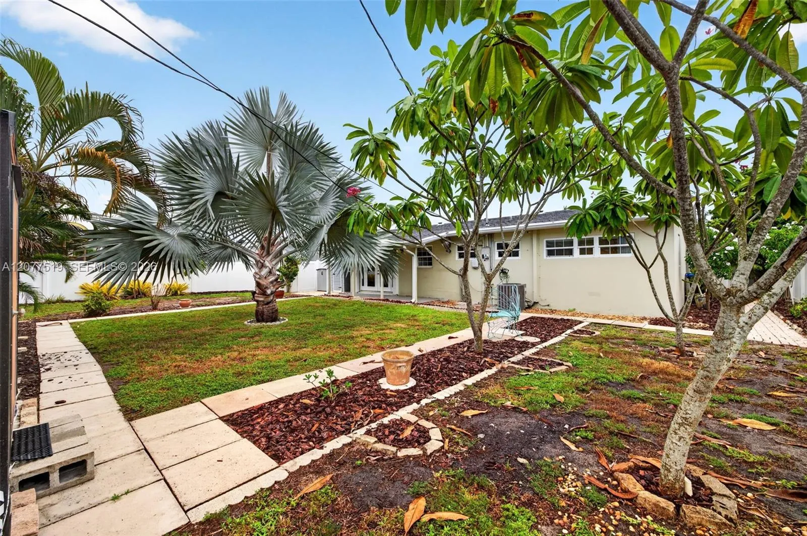 Spacious side yard provides additional outdoor space and convenient property access.