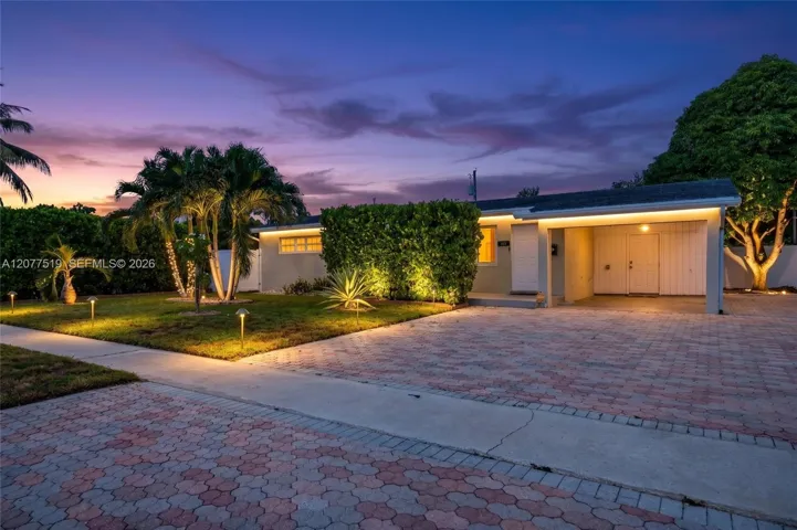 Charming single-story home with a welcoming front entry, covered carport and mature landscaping. Virtually-Enhanced
