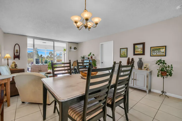 DINNING, LIVING ROOM AREAS LOOKING OUT TOWARDS THE SCREENED PATIO