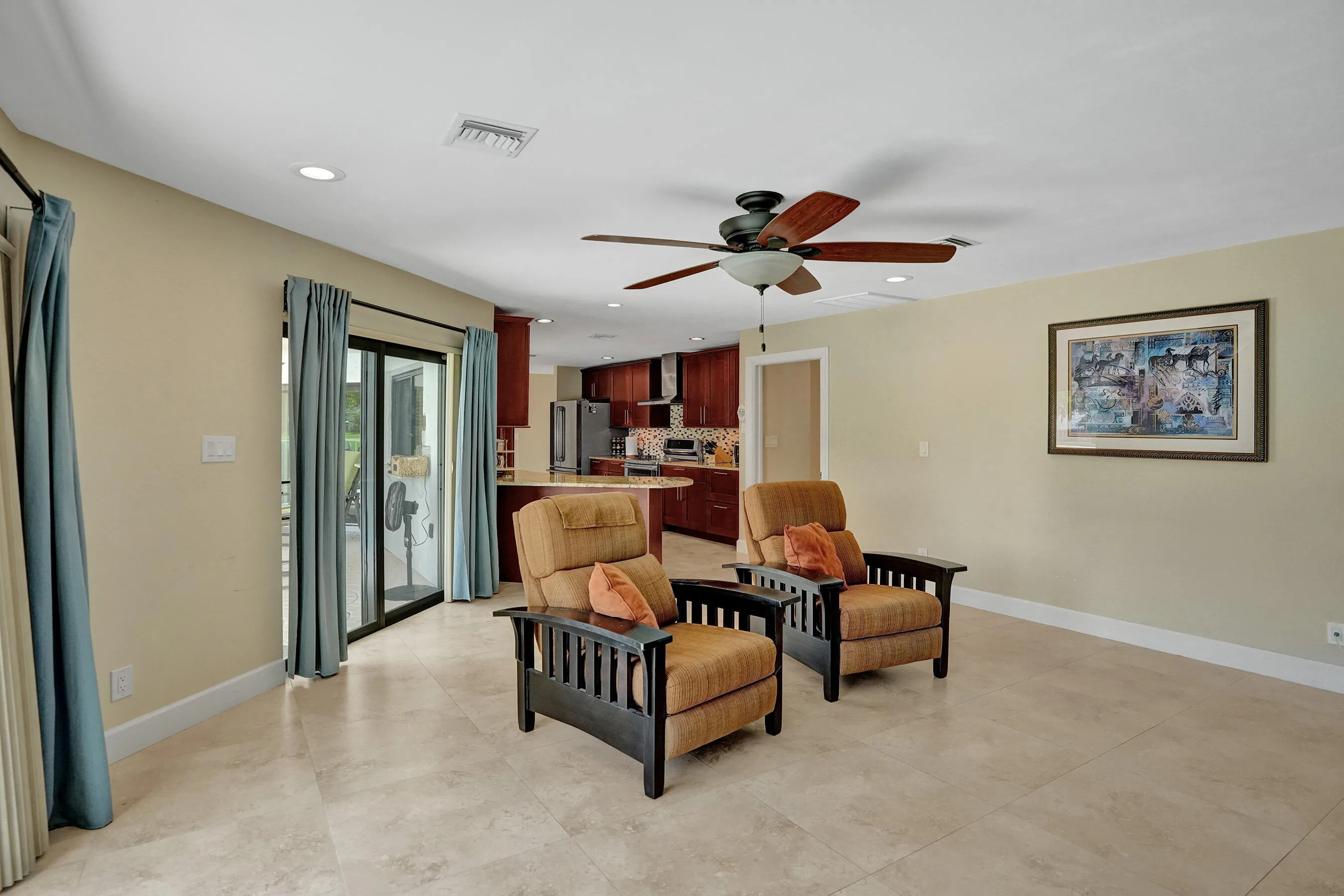Recessed lighting, ceiling fan, sliding glass doors, and tile flooring