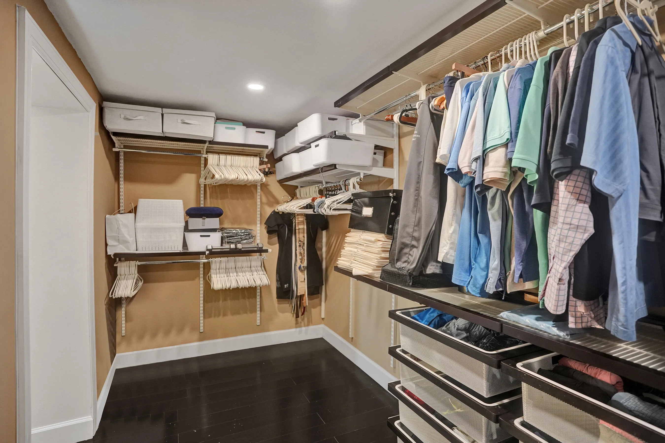 Recessed lighting illuminating dark wood-finish flooring
