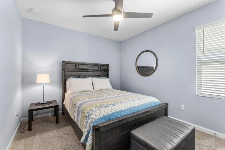Carpeted flooring, window with blinds, and a ceiling fan with integrated lighting