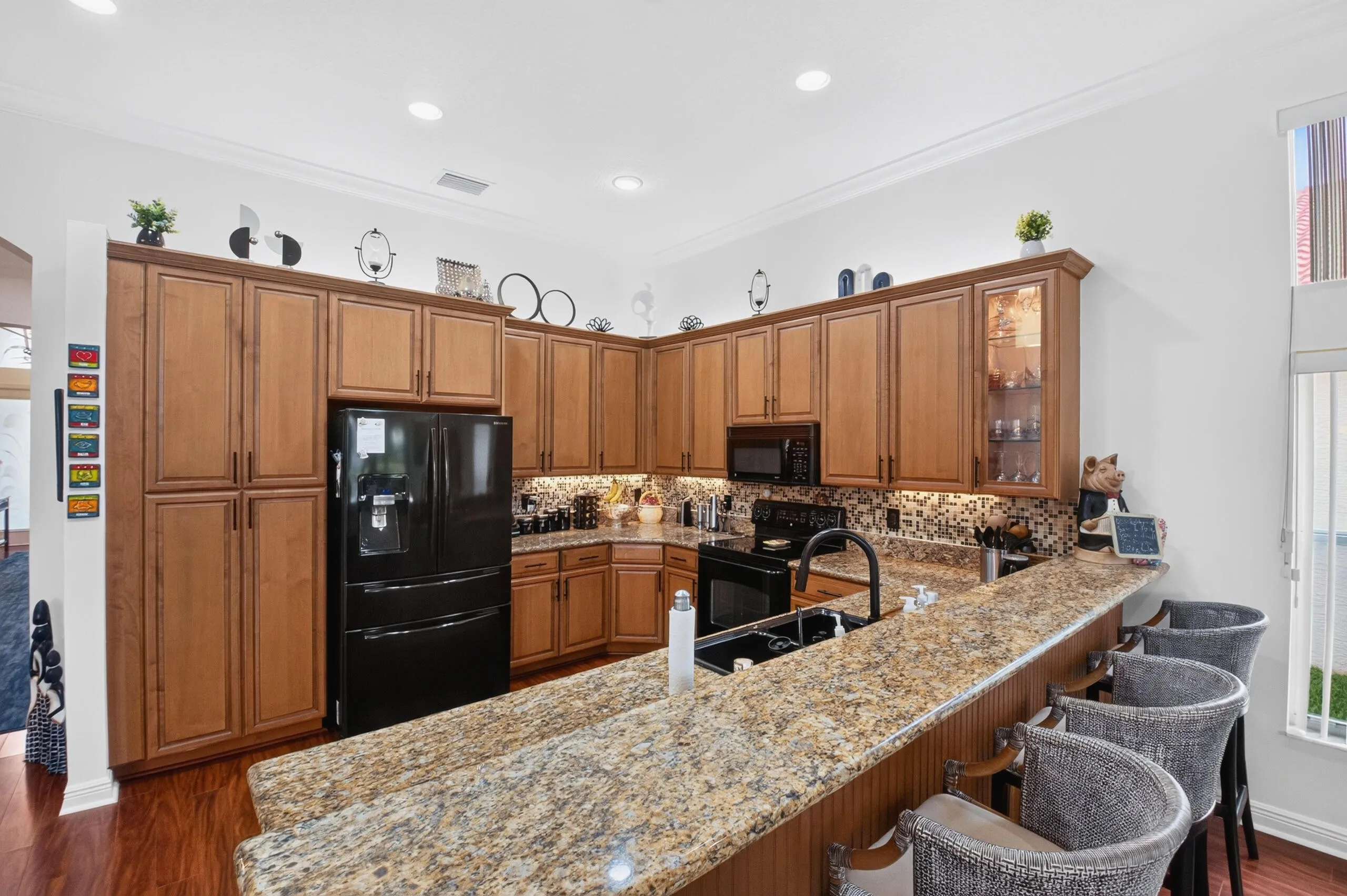 Elegant granite countertops & an attractive backsplash compliments the kitchen's sophisticated design.