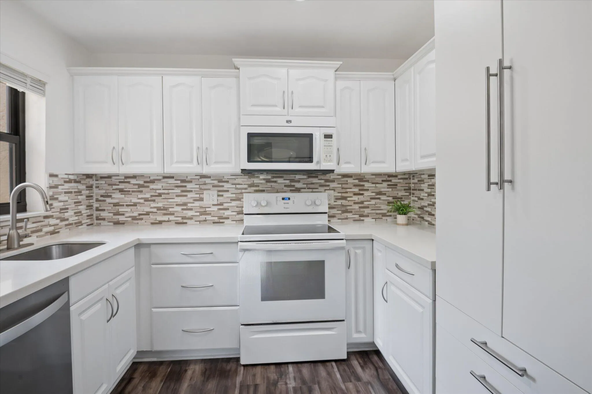 Bright and white kitchen and oversized pantry for storage