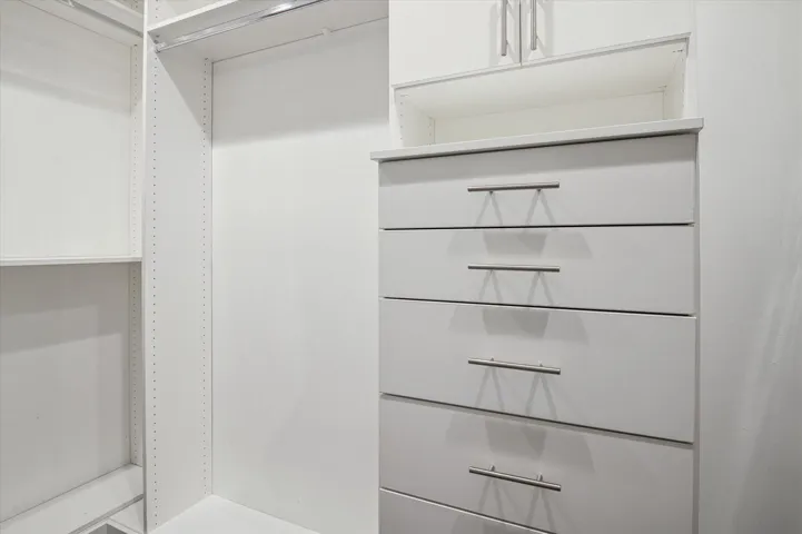 Primary walk-in closet with built-ins