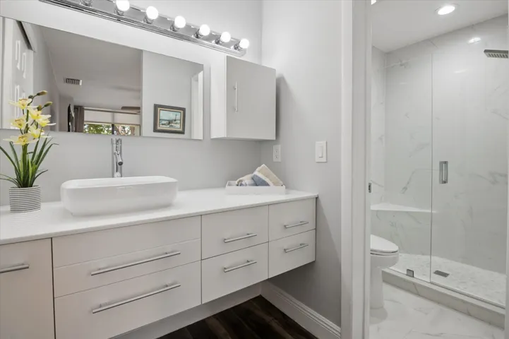 Updated primary bathroom with ample storage and counterspace