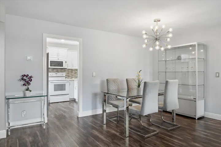 Dining area with beautiful chandelier and close proximity to kitchen