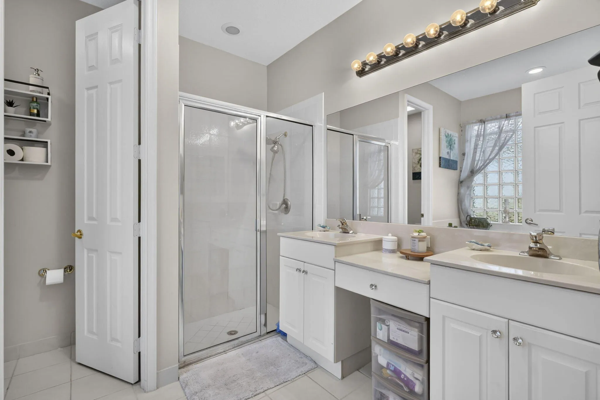 Dual vanity with integrated sinks, full-width mirror, and dedicated vanity lighting
