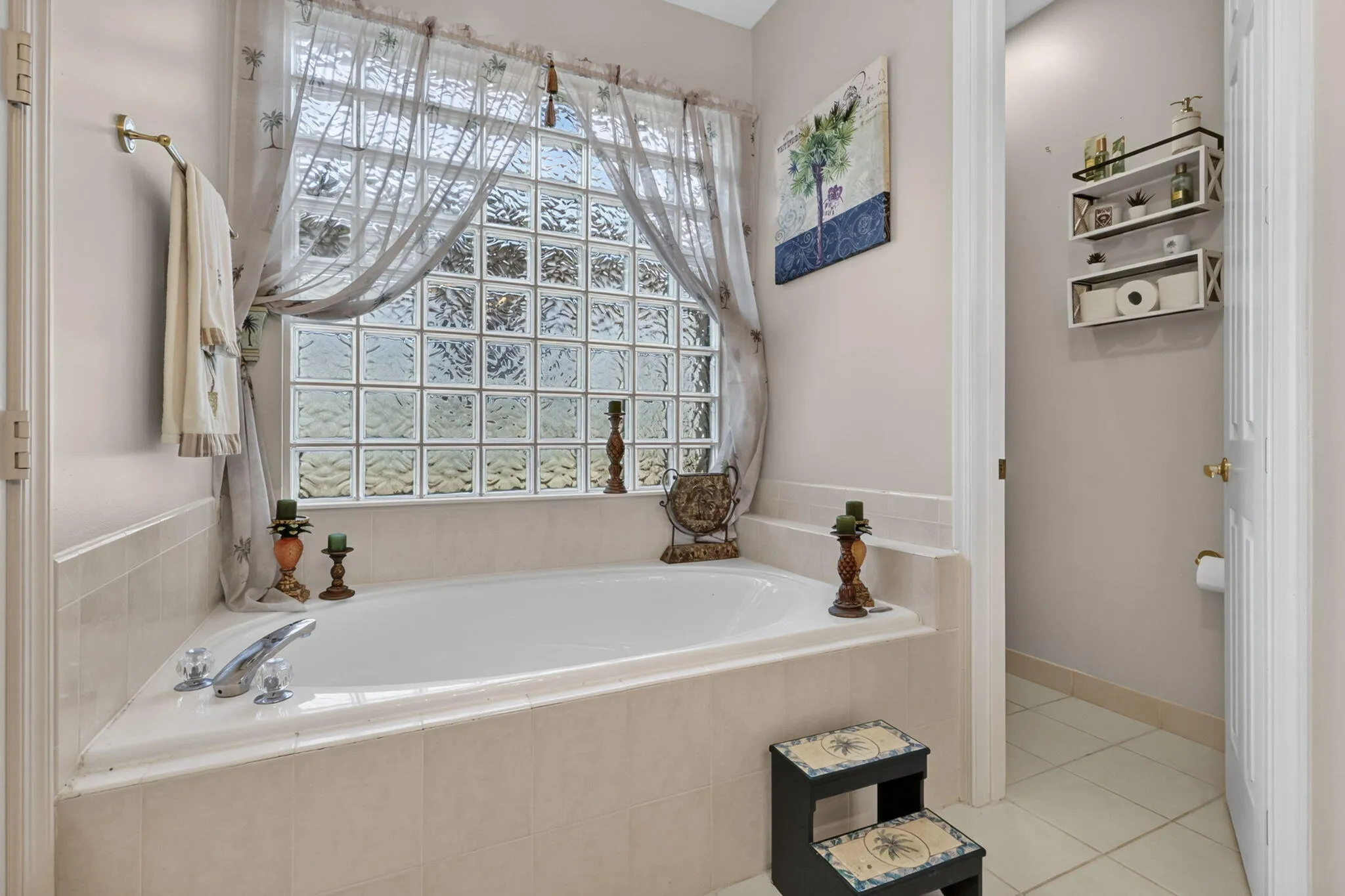 Built-in corner soaking tub with tile surround and chrome fixtures