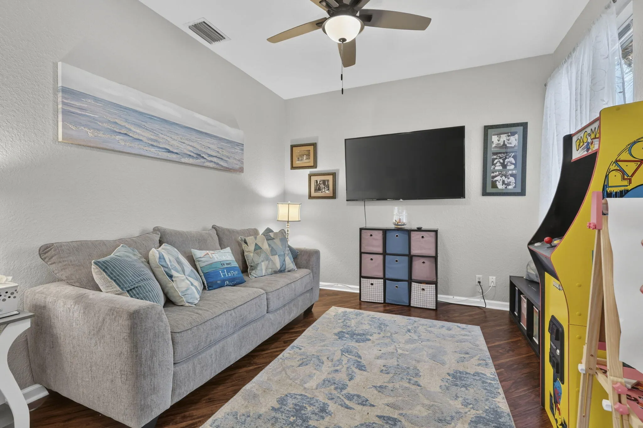 Wood-finish flooring with a ceiling fan light fixture