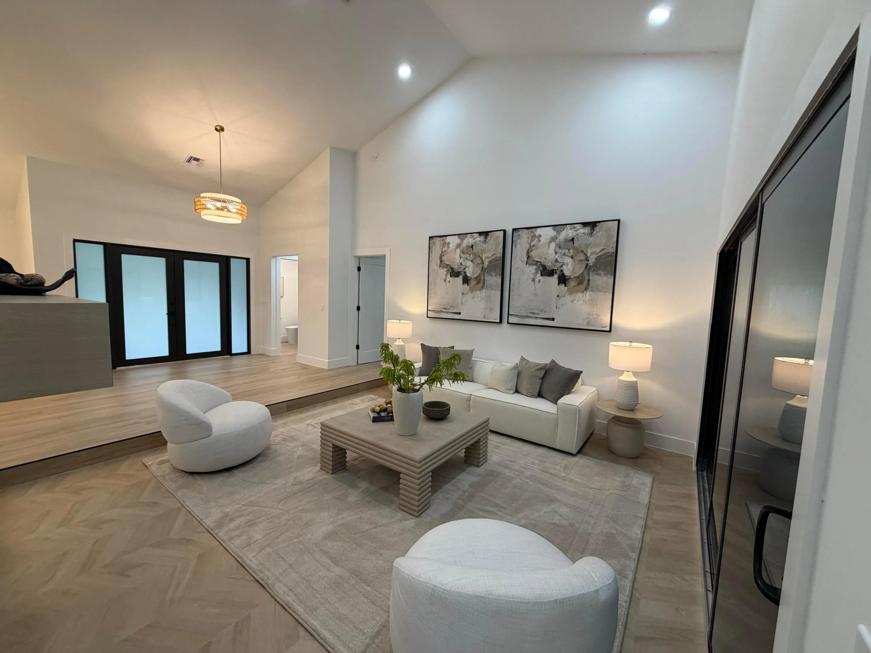 Vaulted ceilings, recessed lighting, and wood-finish flooring with a herringbone pattern