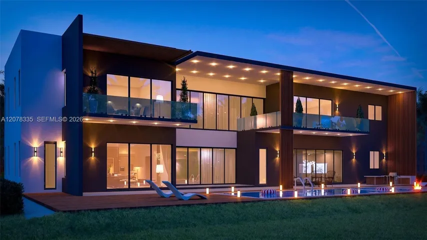 Stunning twilight view of the rear pool area and glass-walled modern architecture.