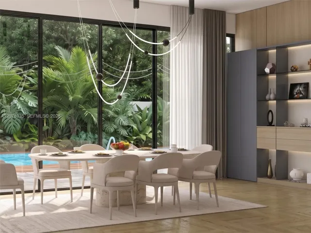 Elegant dining area with floor-to-ceiling windows framing lush garden and pool views.
