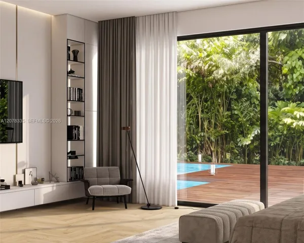 Sunlit family room with floor-to-ceiling sliding glass doors opening to the resort-style pool.