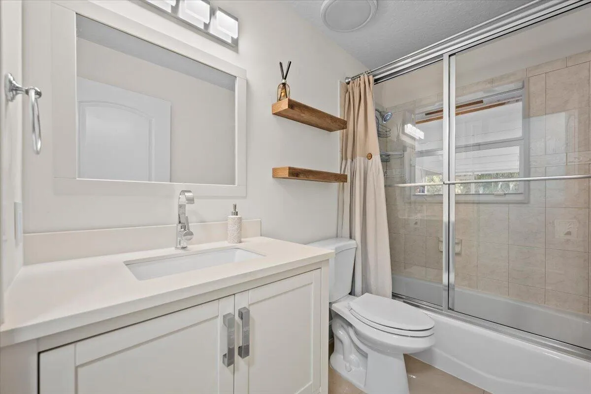 Fresh, bright, and thoughtfully finished. This inviting guest bath offers a clean, modern vanity and tiled tub/shower combination, creating a comfortable space for guests to feel right at home.