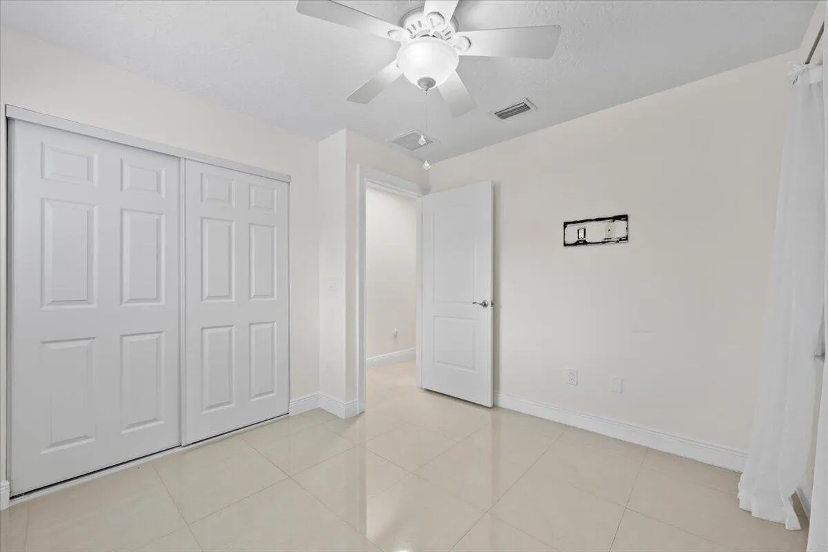 A bright and welcoming space ready to feel like home. Natural light from multiple windows, a ceiling fan, and ample closet space create a comfortable retreat with plenty of possibilities.