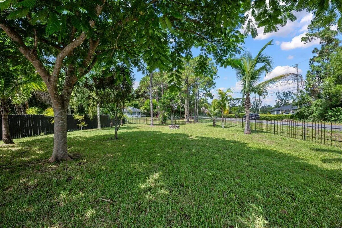 Mature trees create a natural canopy of shade throughout the property, offering cool, peaceful places to relax and enjoy the outdoors. It’s another little touch that makes this backyard feel like a true Florida retreat.