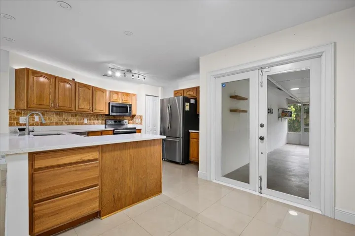 The heart of the home welcomes you with a bright, open kitchen designed to make everyday moments feel effortless. From morning coffee at the peninsula to evenings flowing onto the screened patio, this is where Florida living begins to feel like home.