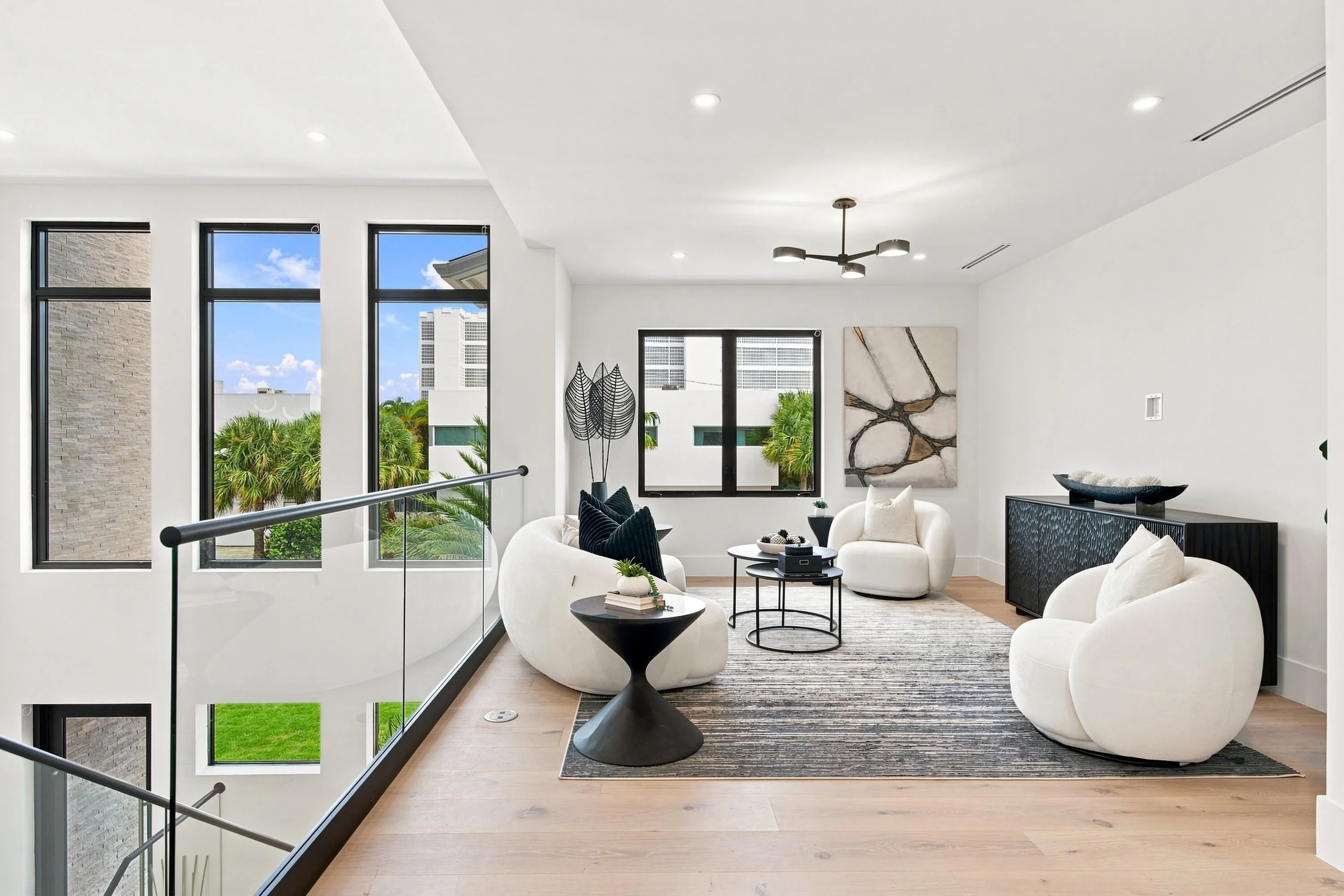 Light wood-finish flooring, recessed lighting, and a modern chandelier