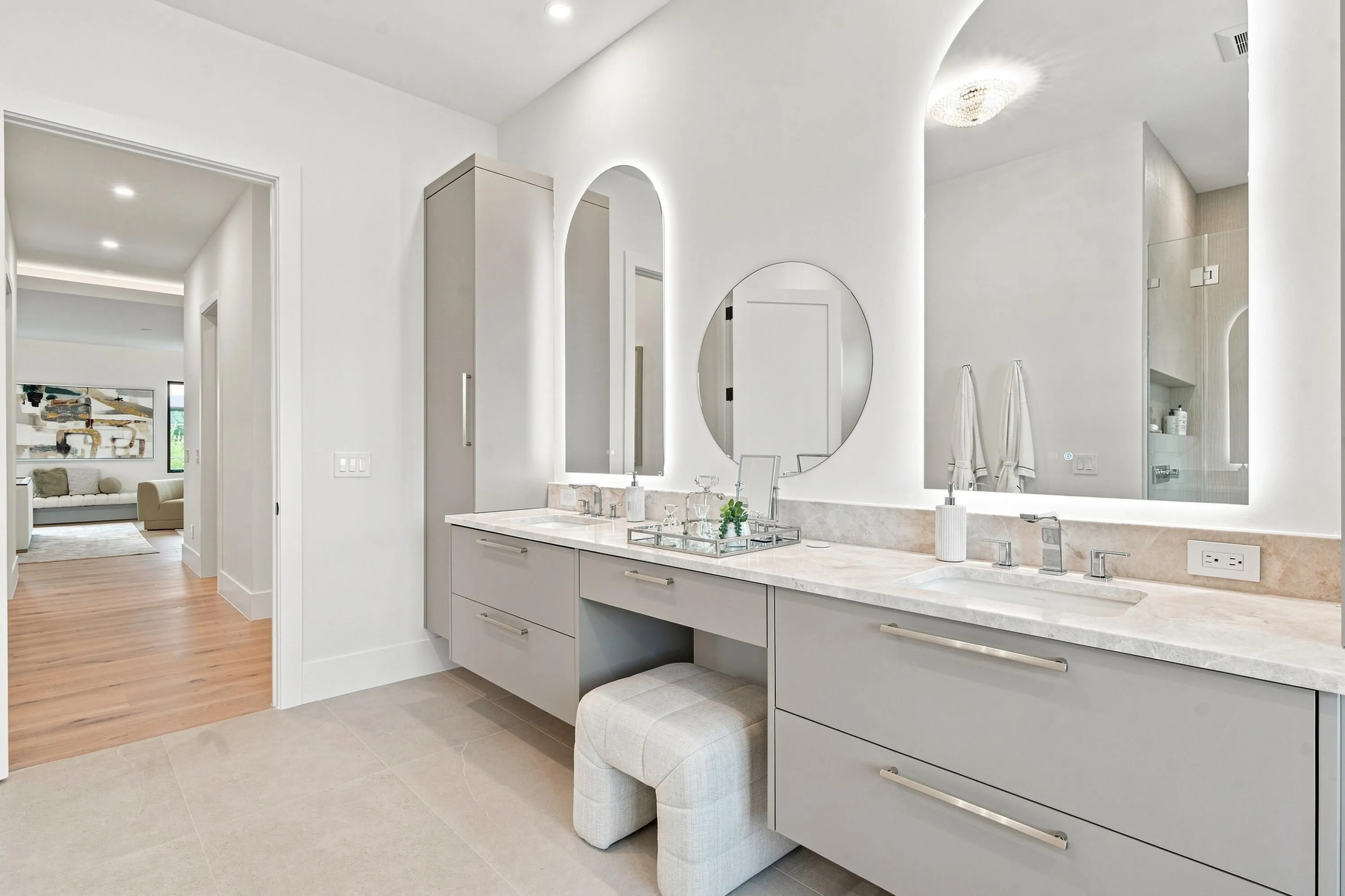 Dual vanity with light gray cabinetry, integrated sinks, and polished chrome fixtures