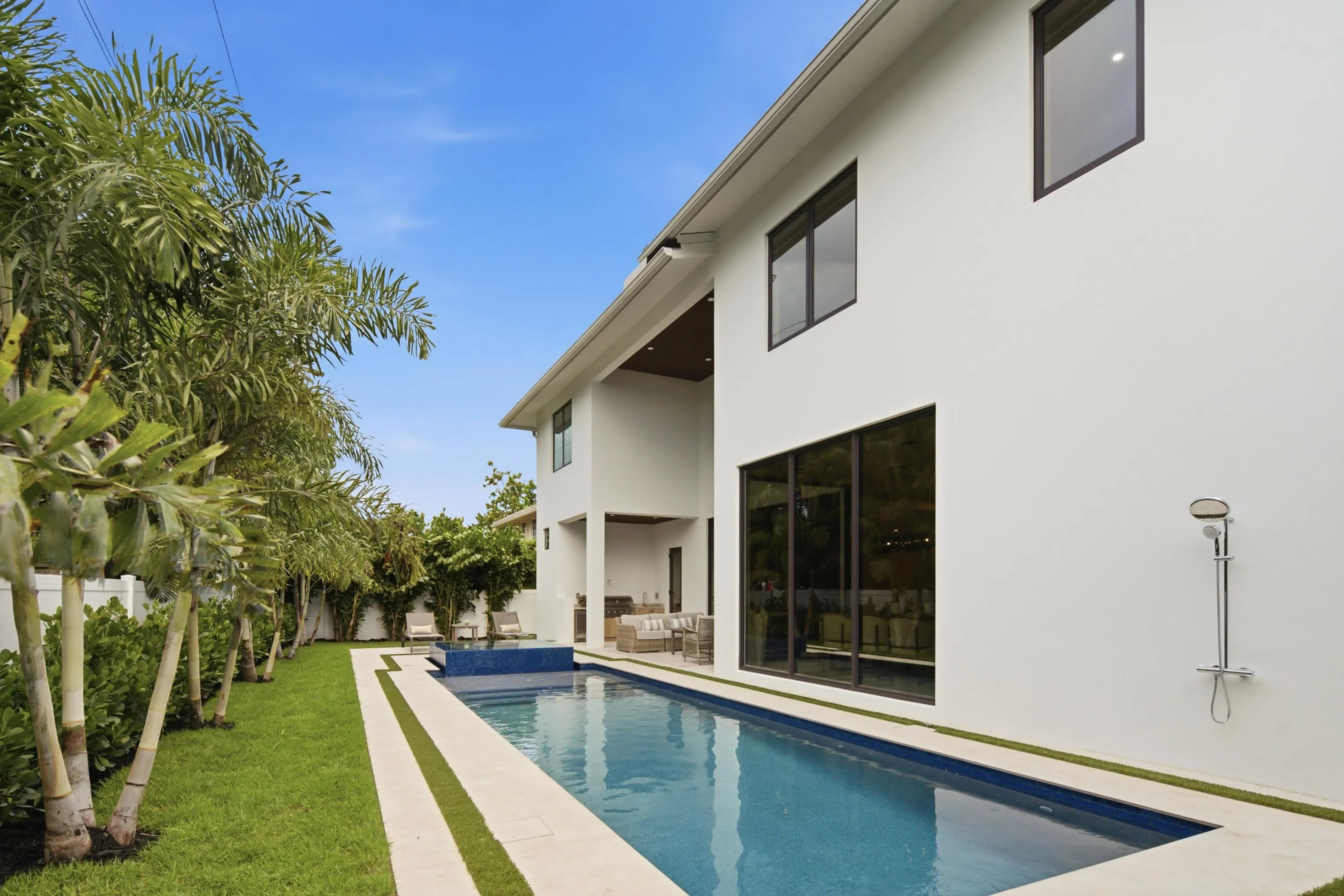 Modern architectural design featuring white stucco exterior and black-framed windows