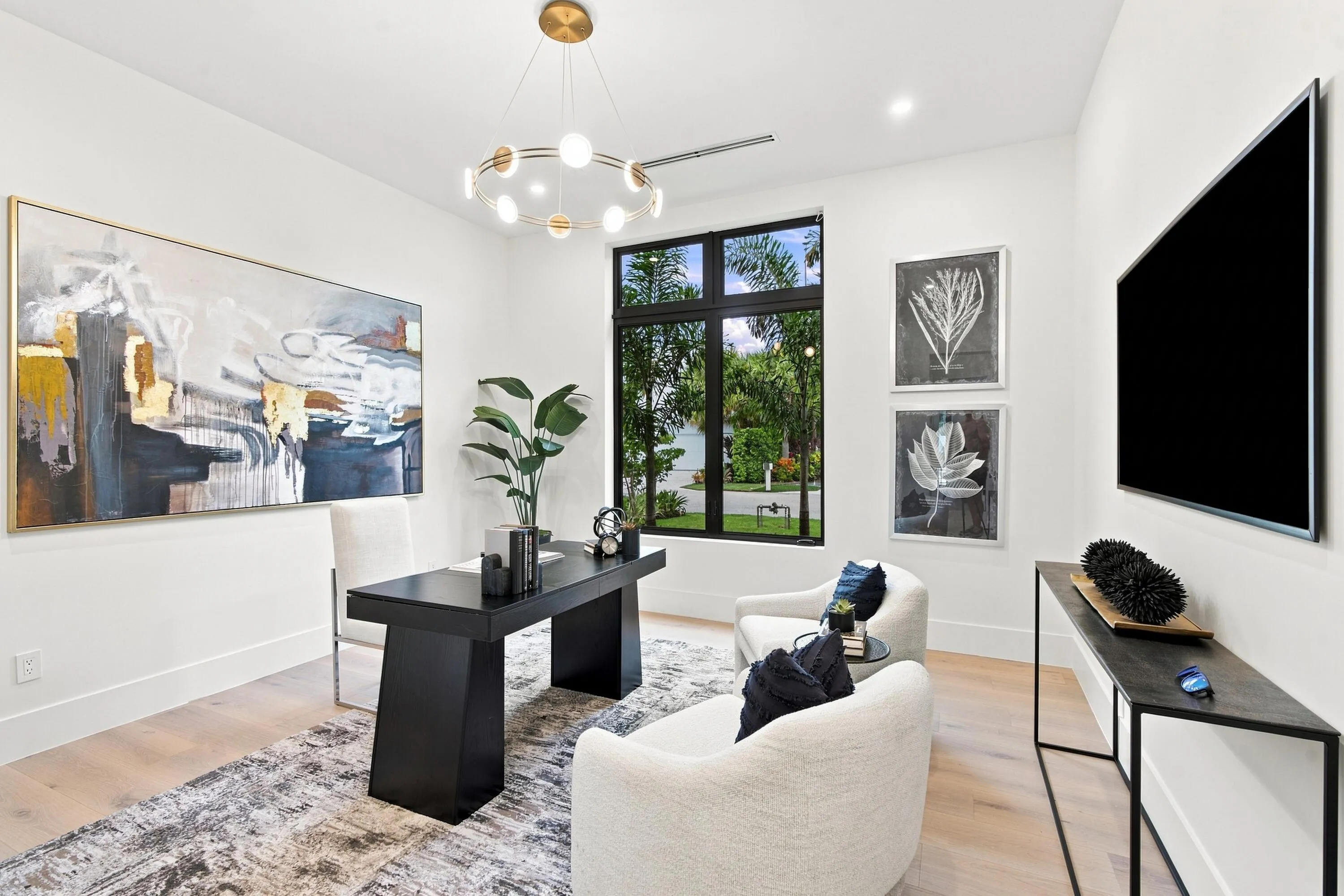 Recessed lighting and a contemporary chandelier illuminate the space